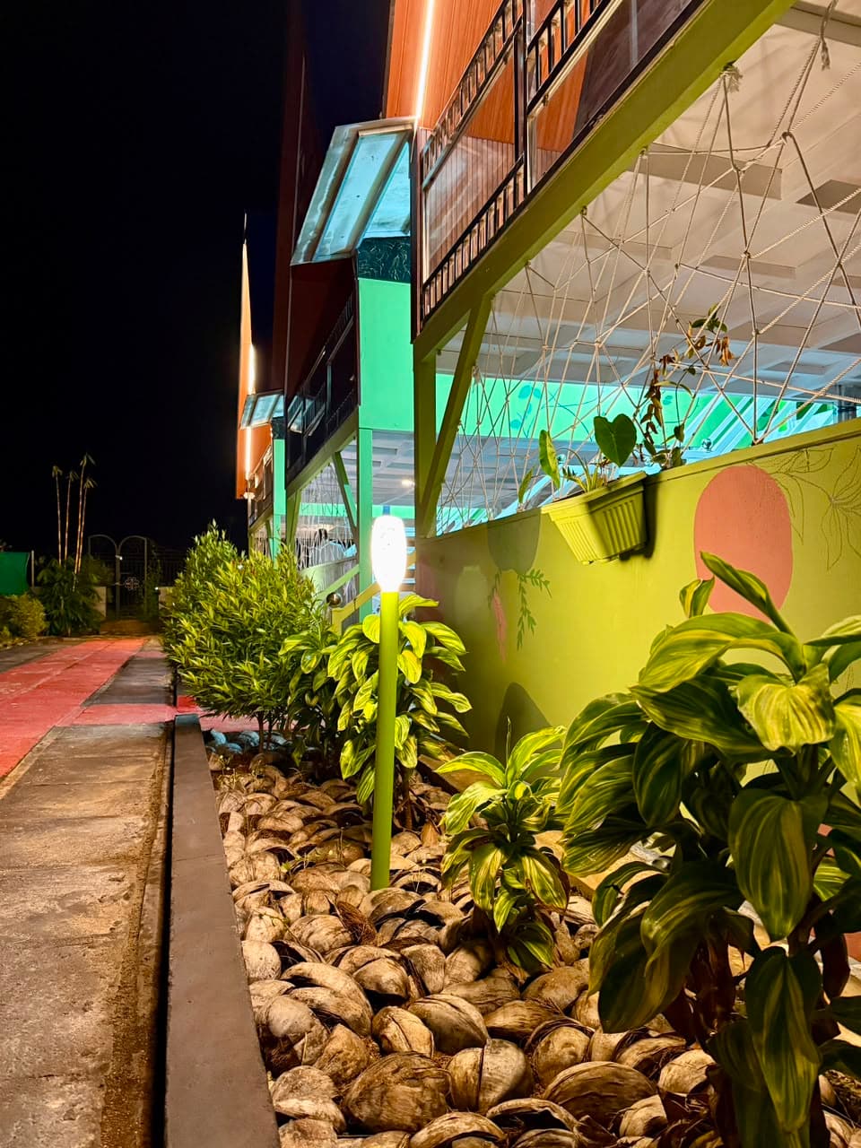 The walkway lit by garden lamps after dark