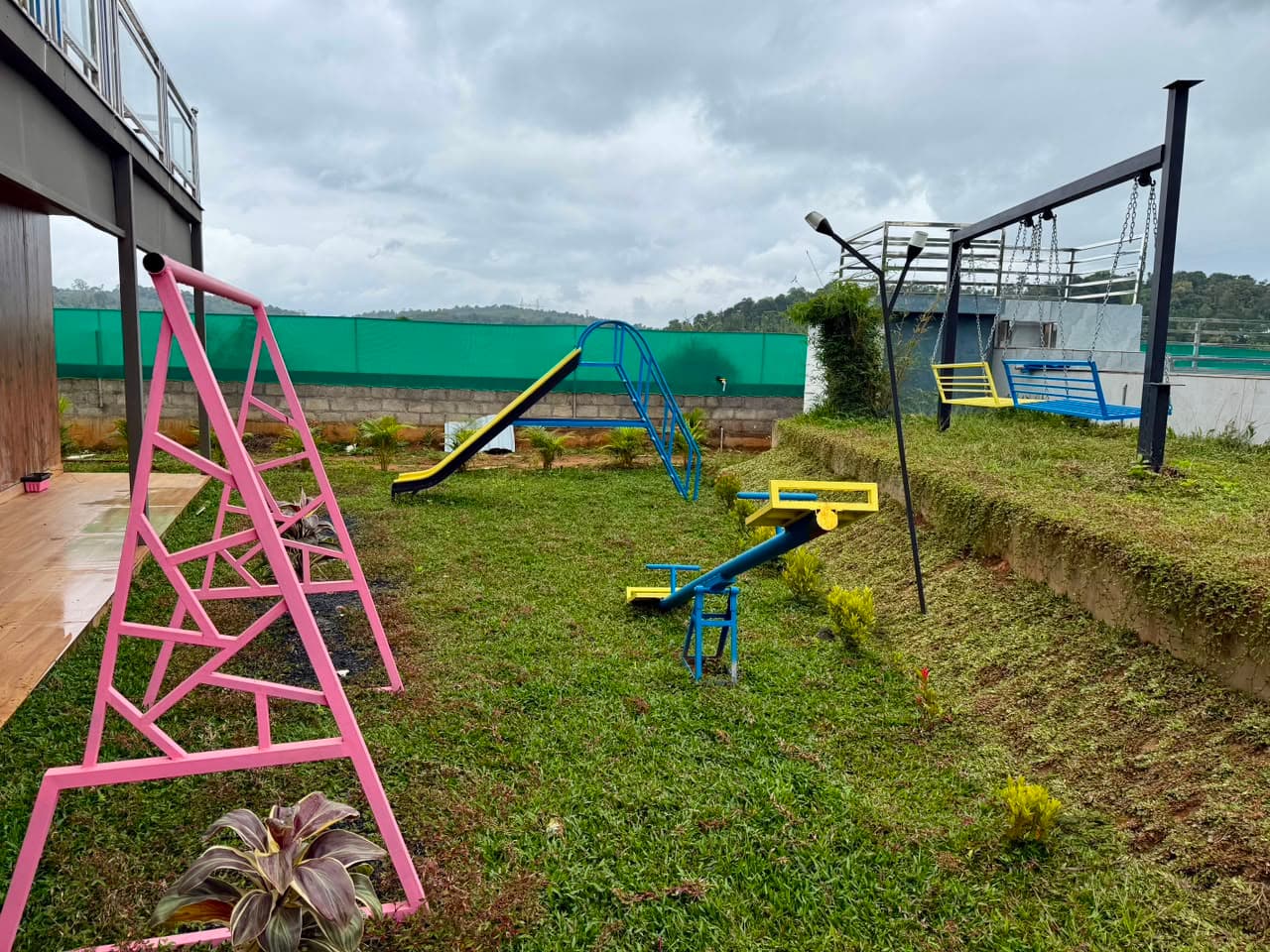 Children's playground and swings at Mist Wave Resort Wayanad