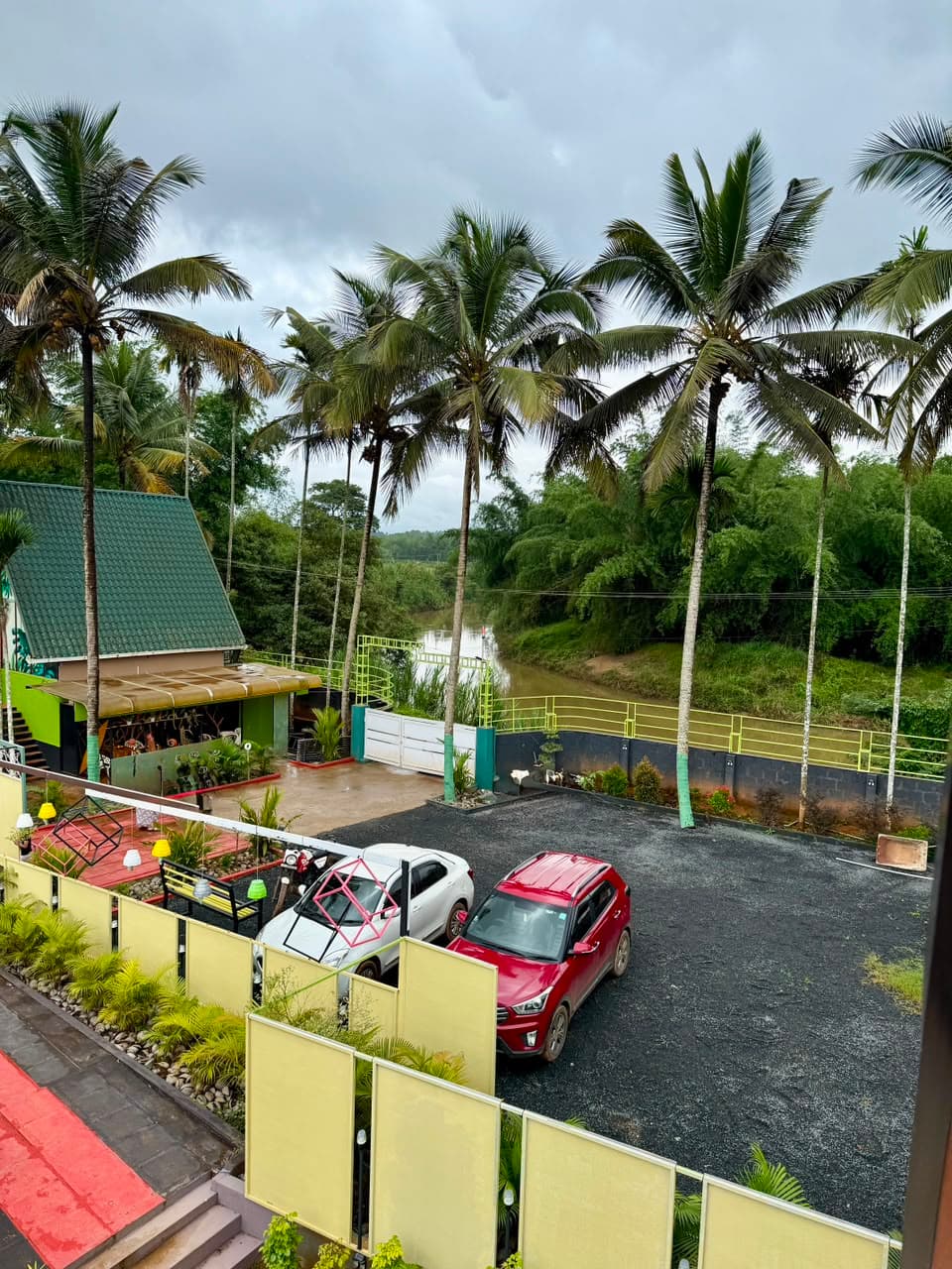 The river and the coconut groves seen over the parking from an upper balcony